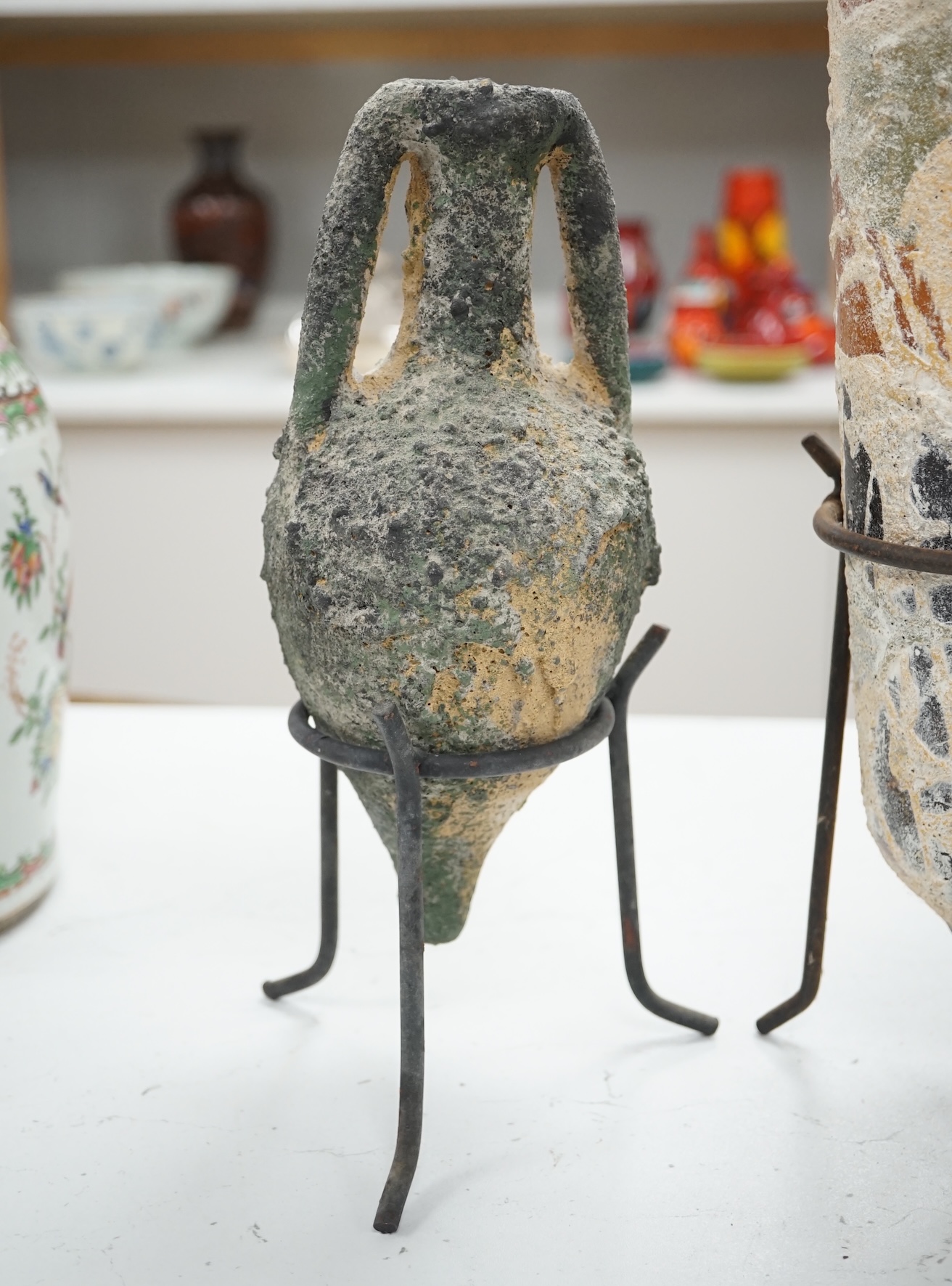 Two pottery amphora on metal stands, tallest 43cm high. Condition - as on line images